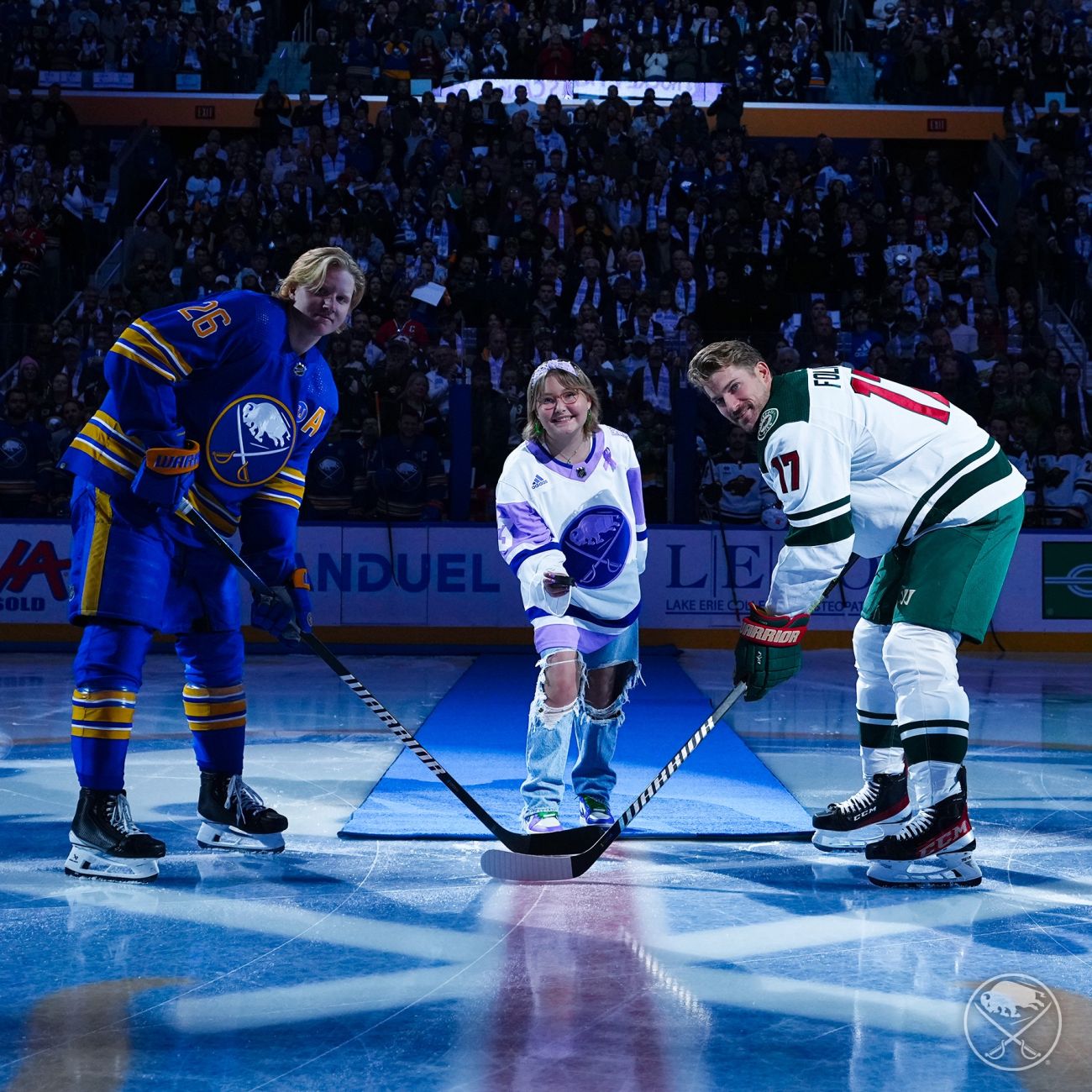 Sophia, a Roswell Park pediatric patient, drops the puck at Hockey Fights Cancer night with the Buffalo Sabres.