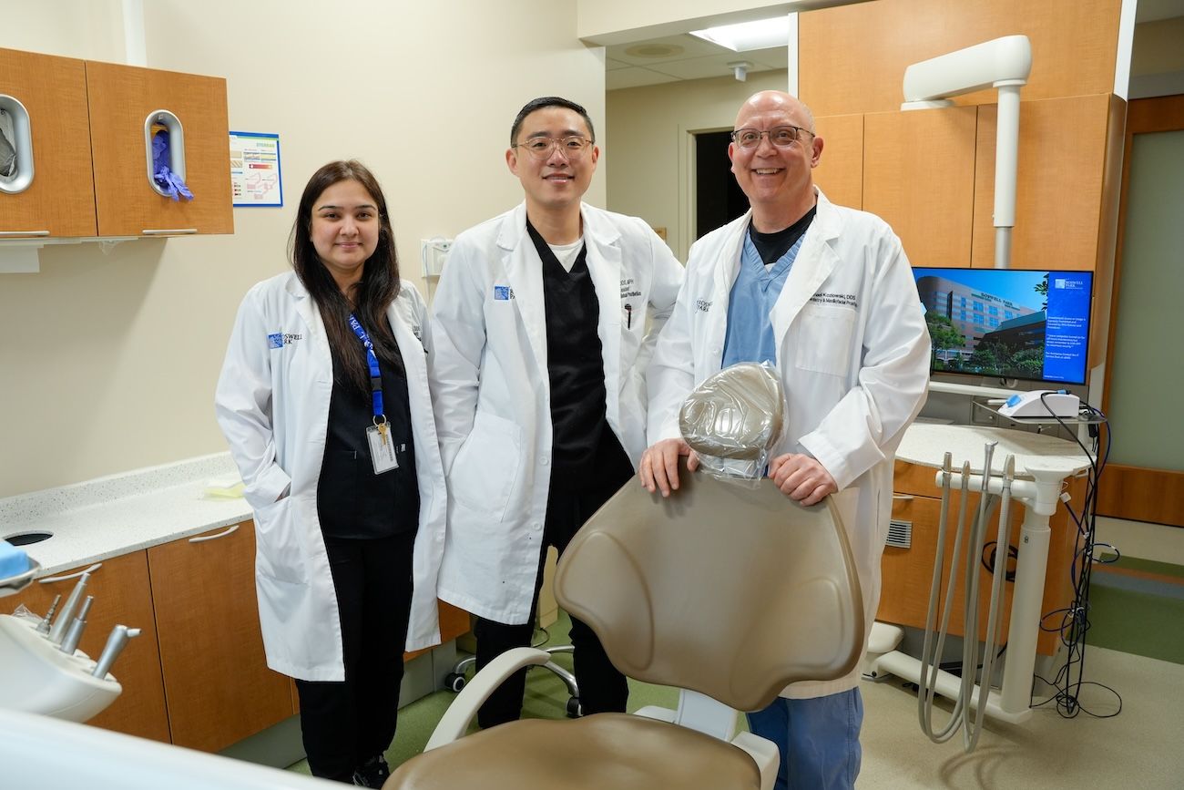 Dr. Michael Kozlowki poses with two dental residents, Dr. Samna Minhas and Dr. Jay Ciano