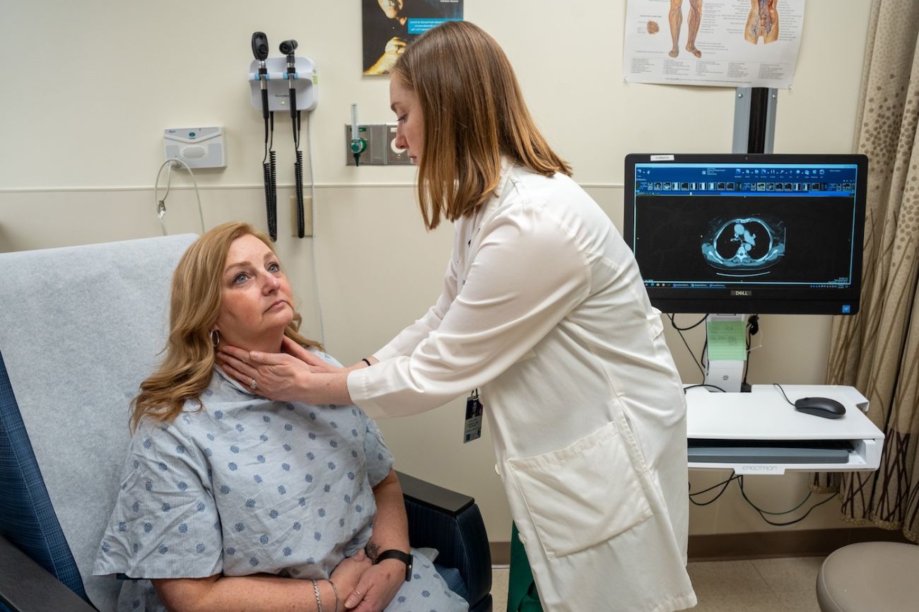 Surgical oncologist Dr. Shalana O'Brien feels a patient's lymph nodes in clinic