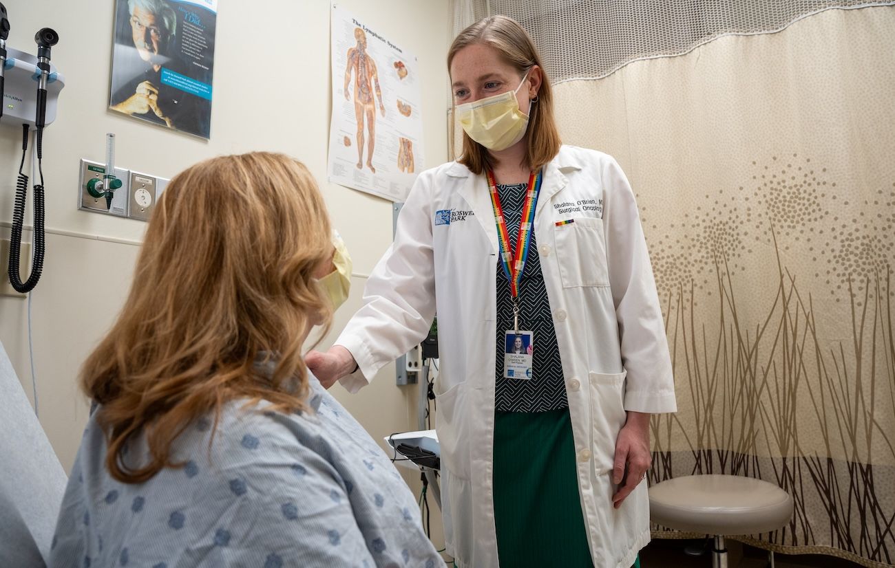 Surgical oncologist Dr. Shalana O'Brien interacts with a patient in clinic 