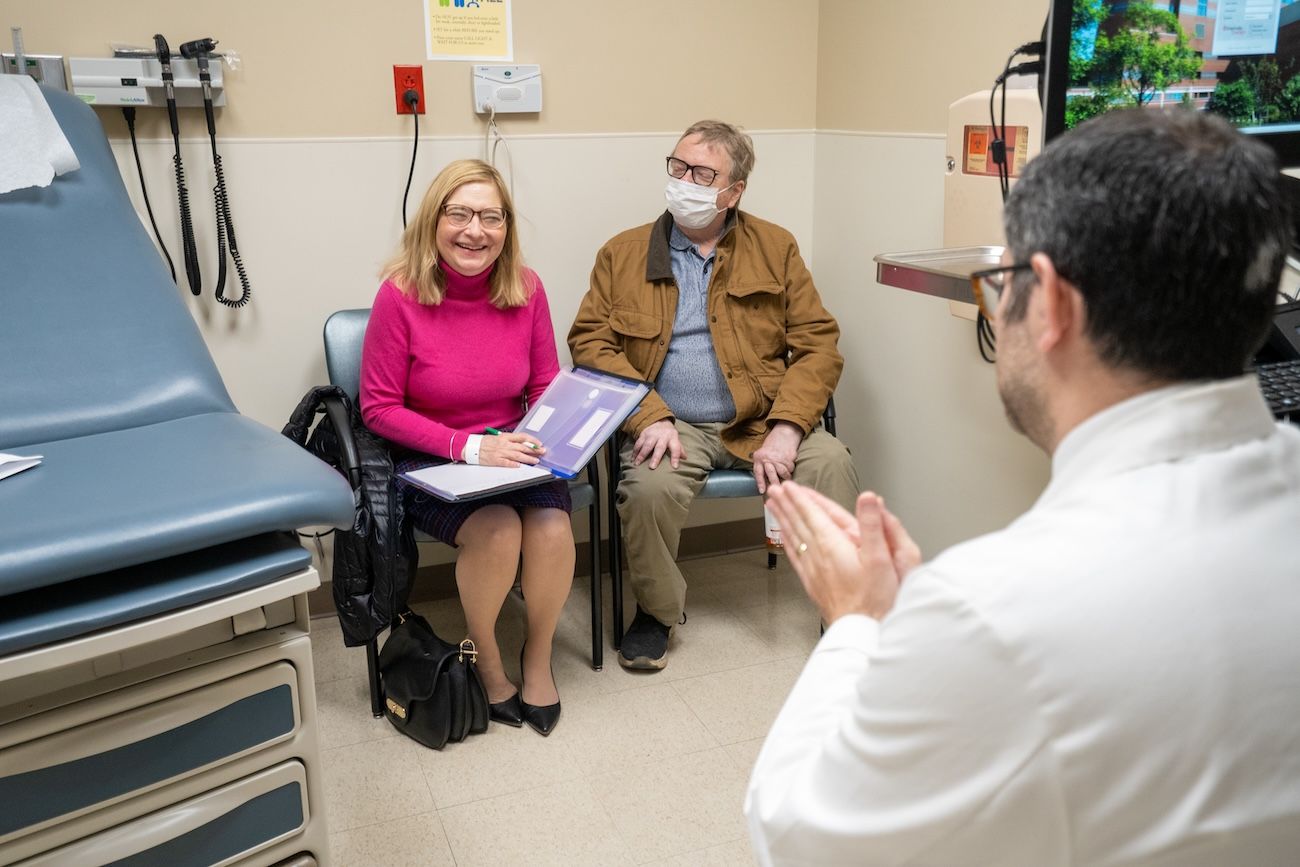 Dr. Anthony Dakwar sits in clinic with a patient and their family before a procedure