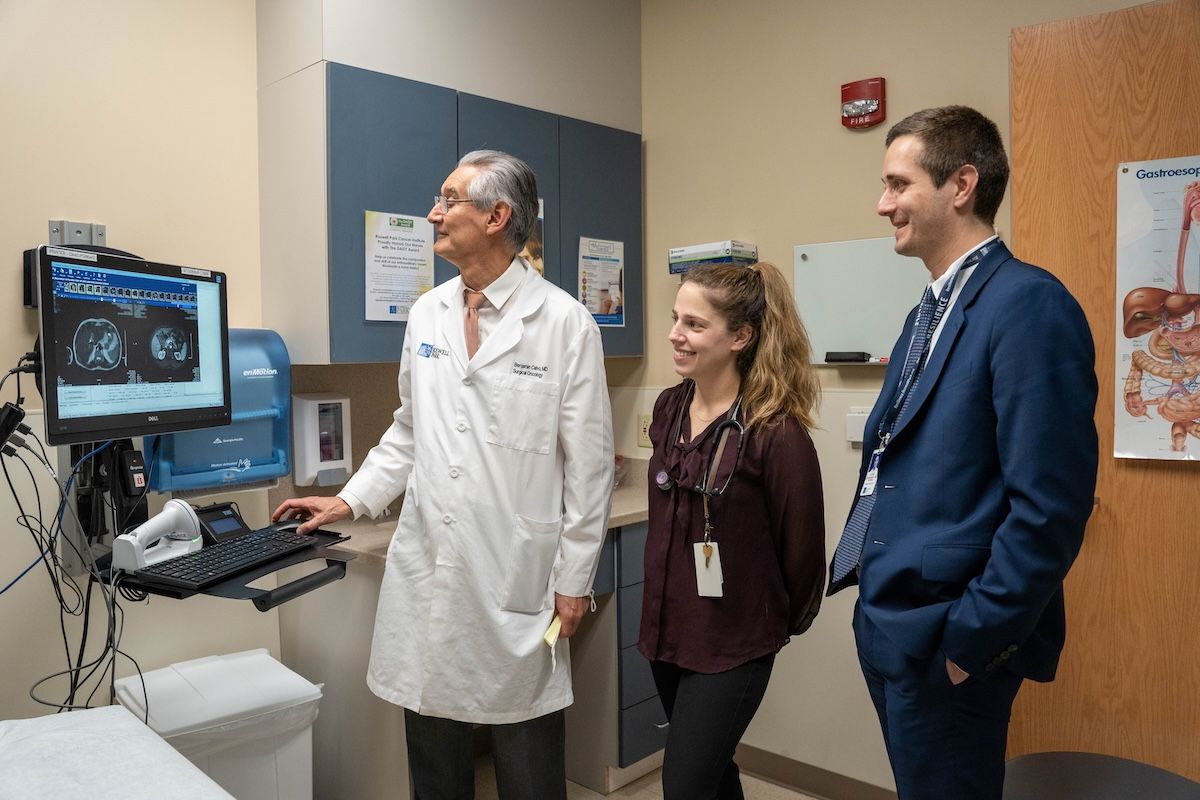 Dr. Benjamin Calvo and Dr. Lenoid Cherkassky stand in clinic looking at a screen