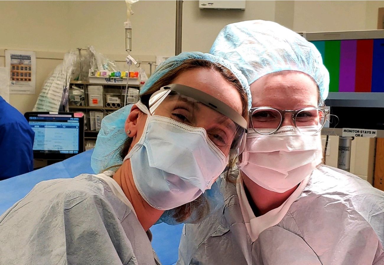Dr. Emese Zsiros and a GYN Oncology fellow pose in the operating room together