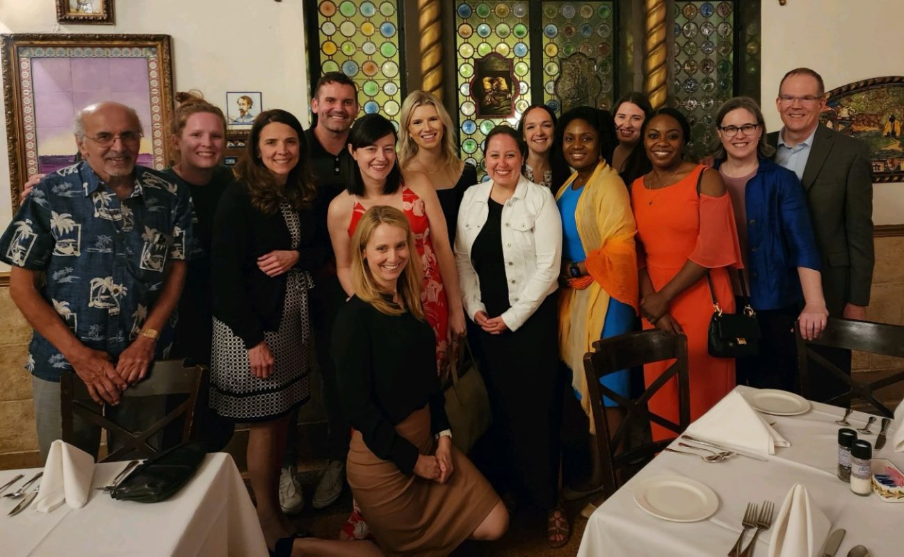 Gynecology team poses together at a restaurant