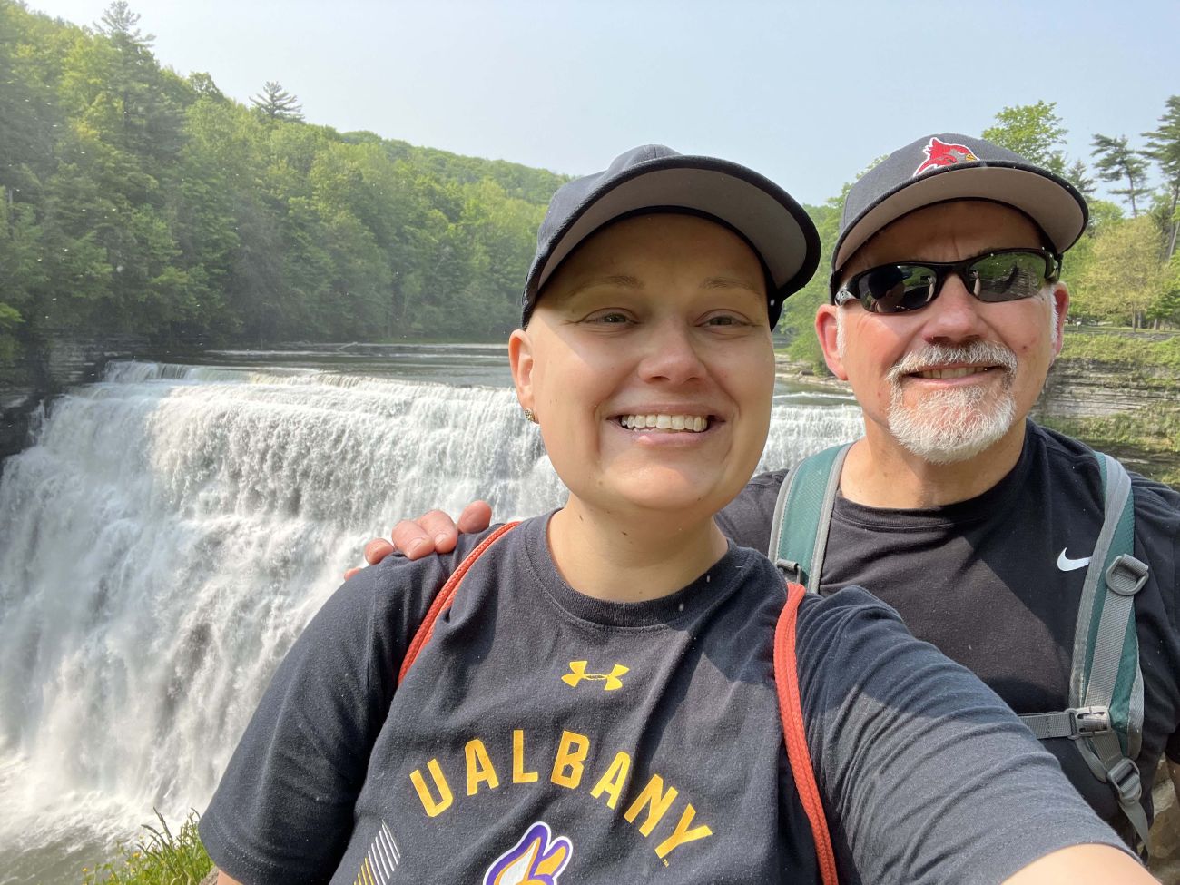 Emily Pacer and her father, Gary, stand in front of a waterfall. 