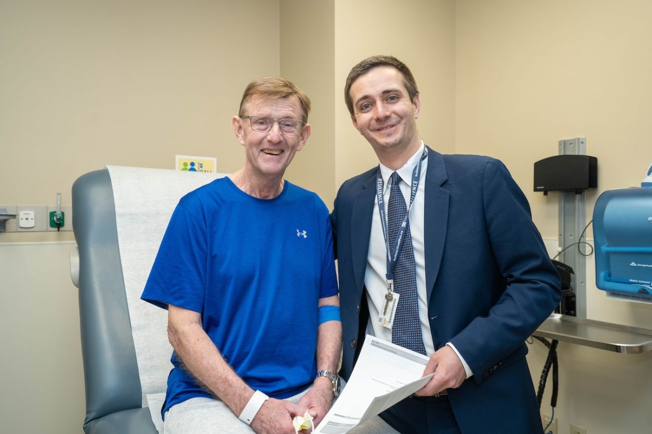 Dr. Leonid Cherkassky smiles with a patient in clinic