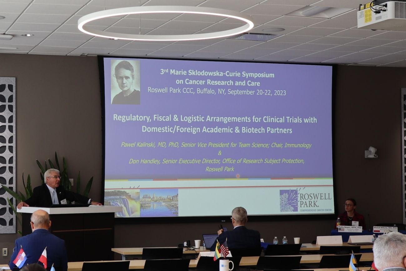 A doctor speaking to a room of researchers