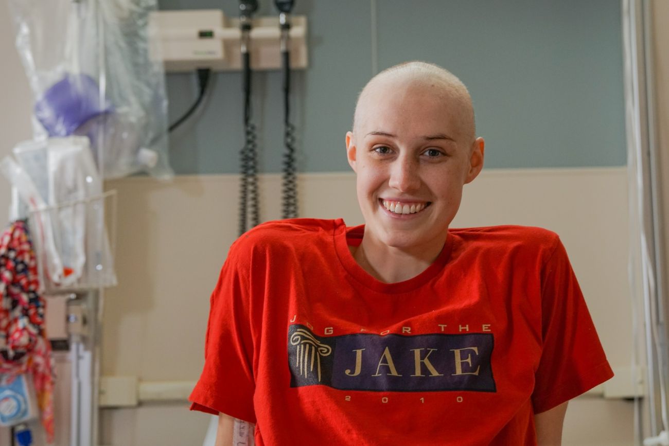 Patient Leah sits in a hospital bed.