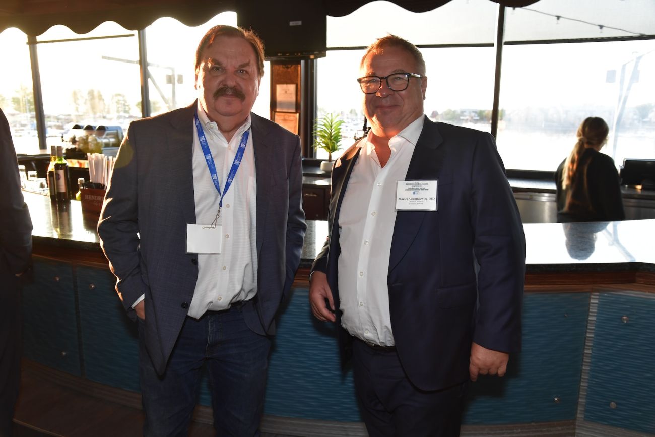 Two scientists speaking at a social event
