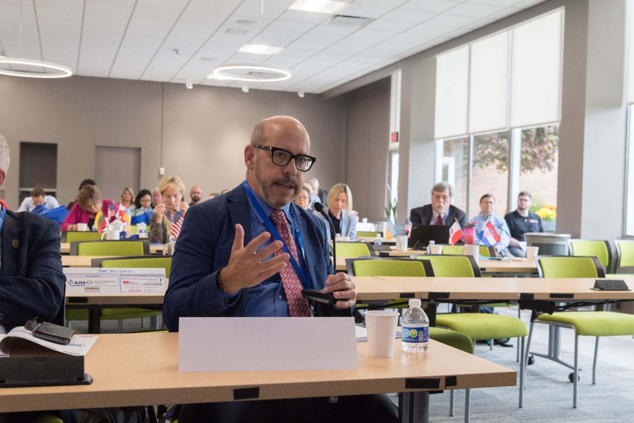 A scientist asks a question during a presentation