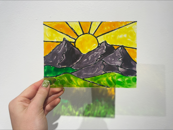 Stained glass painting of a sunset in the Art Heals Gallery for a guided class