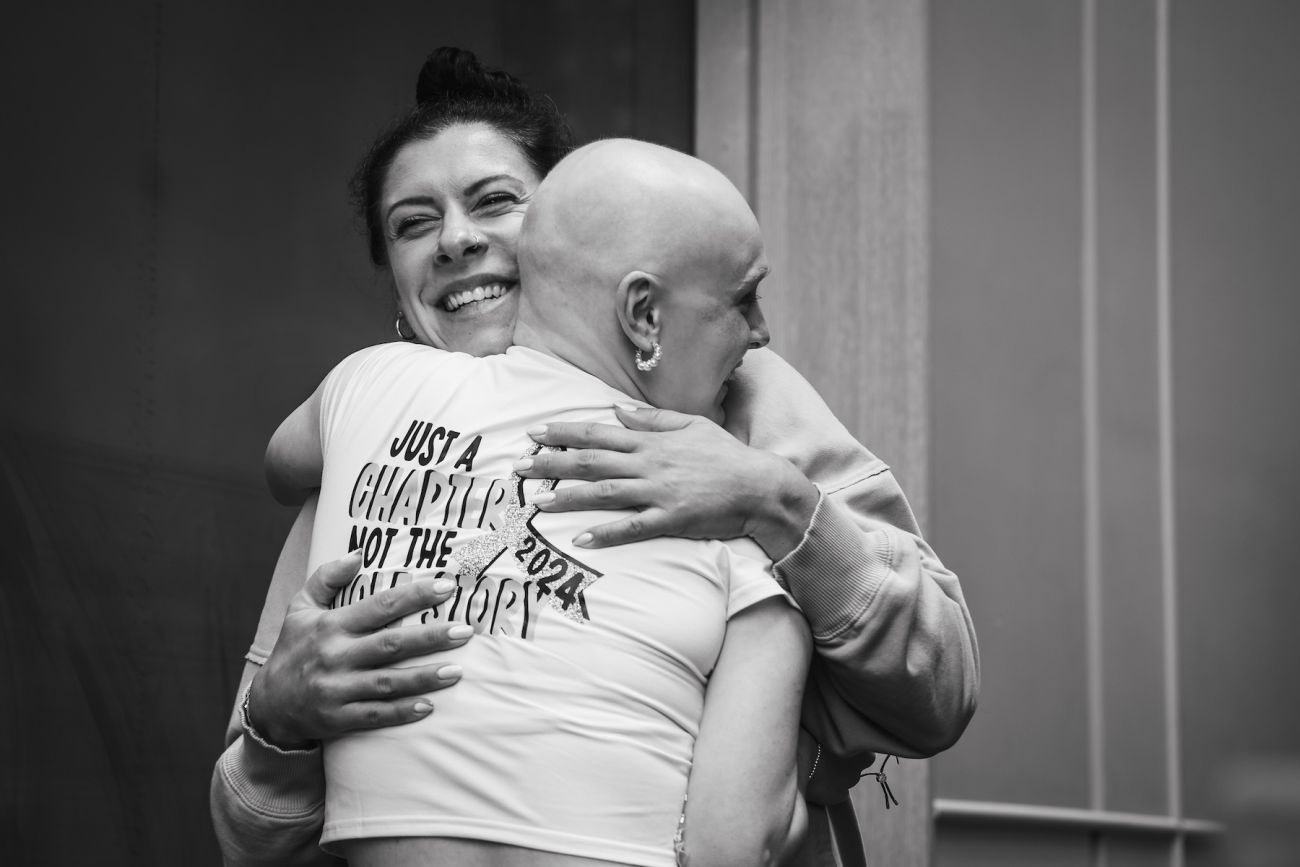 Cancer survivor hugging a loved one