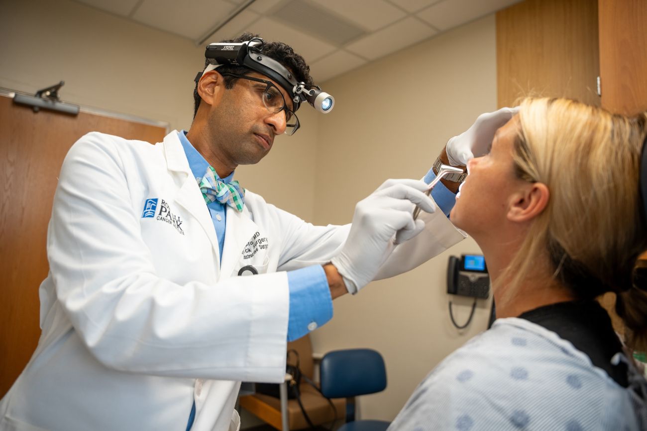 A doctor examines a patient in an exam room
