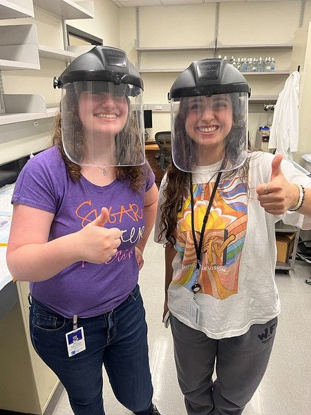 Two women in a lab wearing PPE