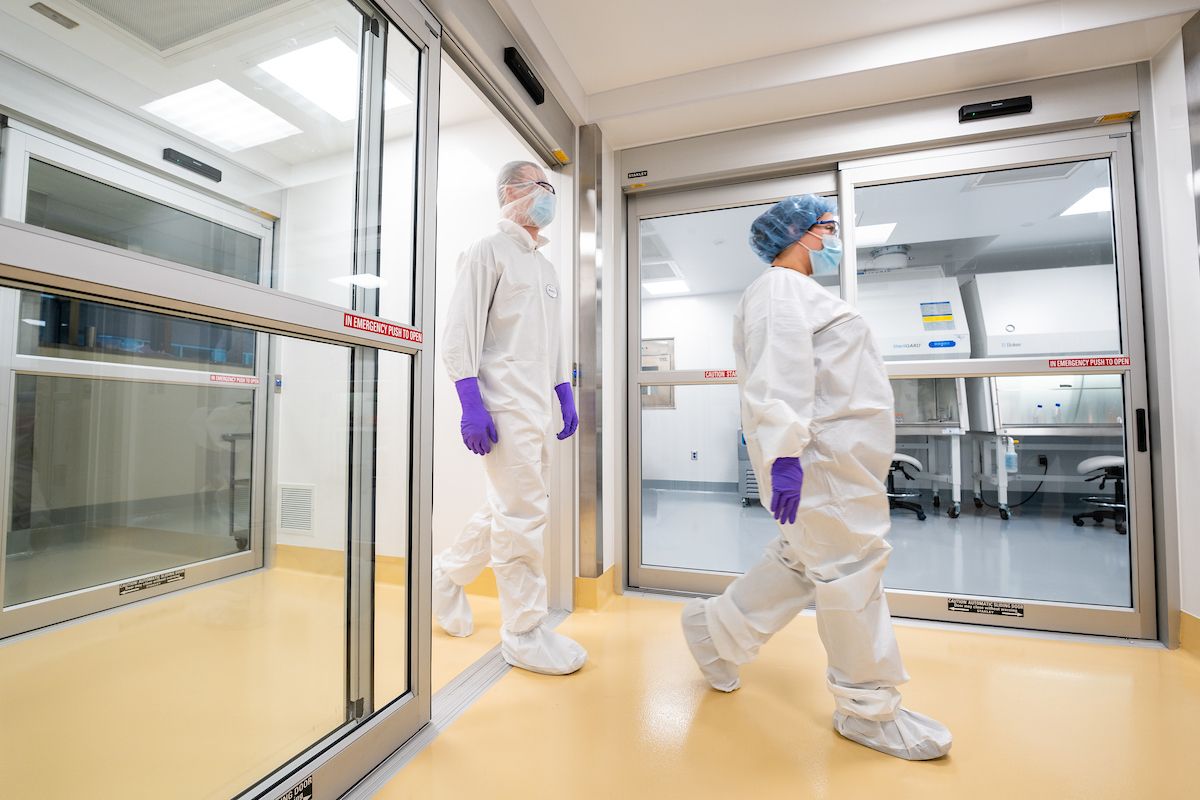 Technicians walk into clean room