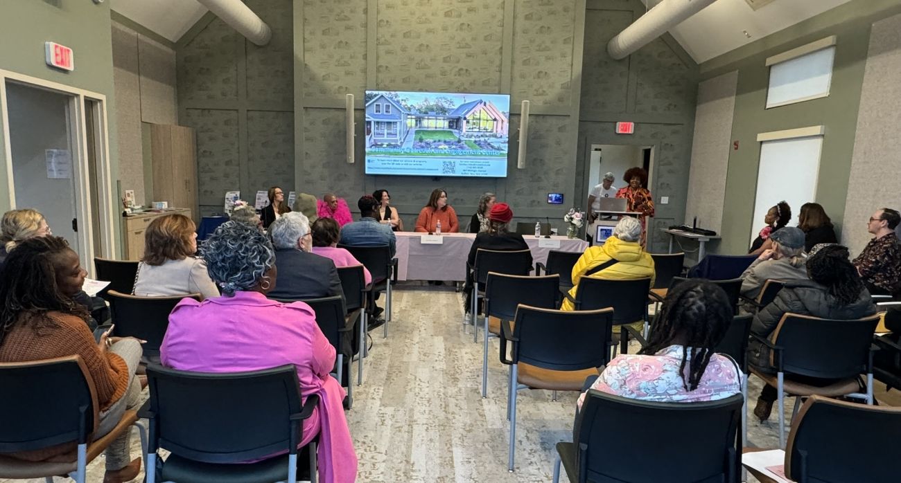 Group of community members sit in the COE building meeting room