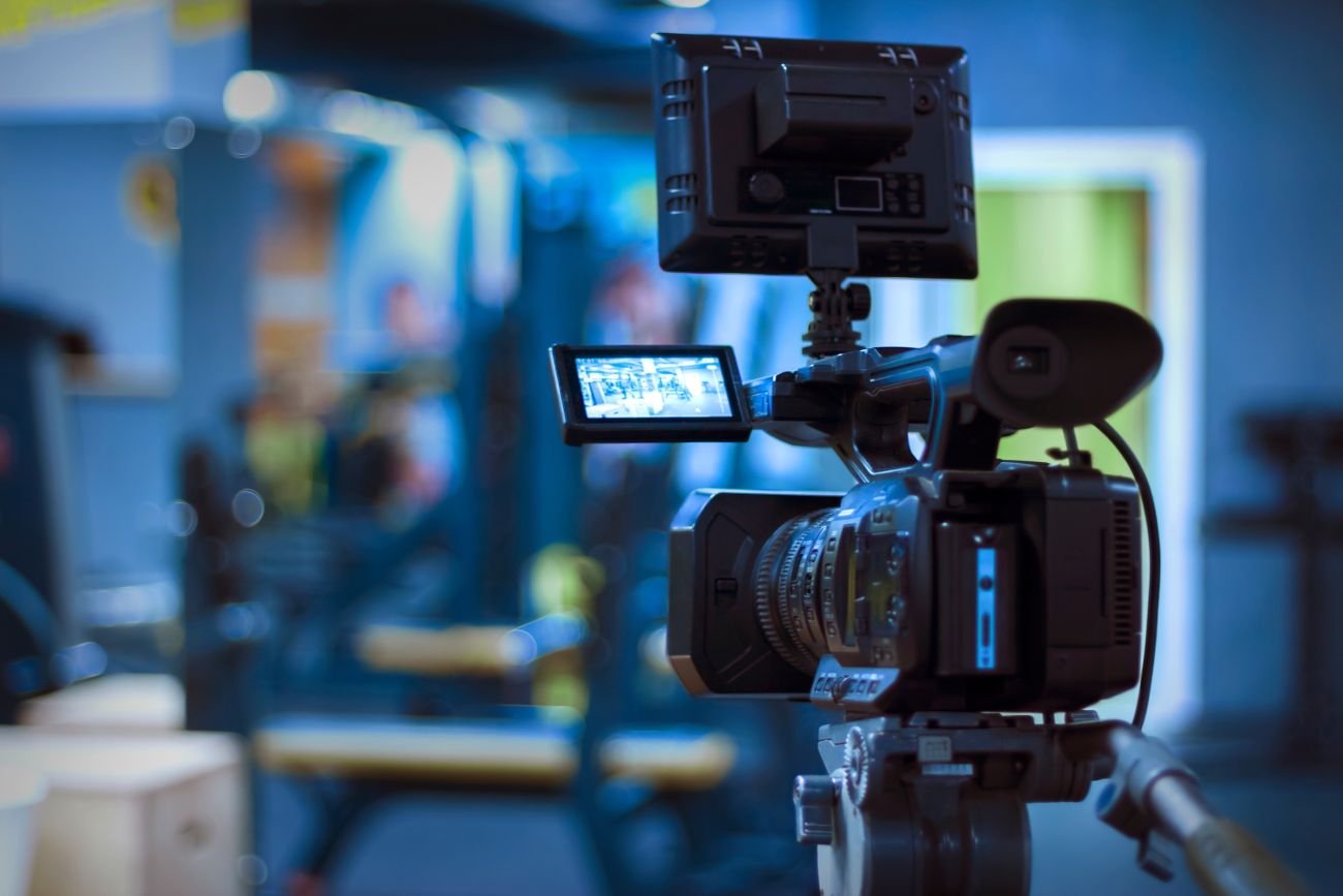 A video camera on a tripod shooting footage