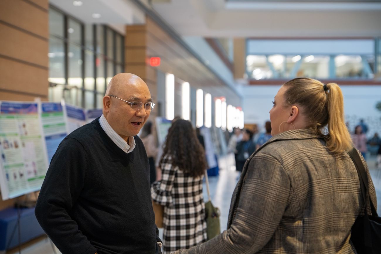 A man speaking with a student