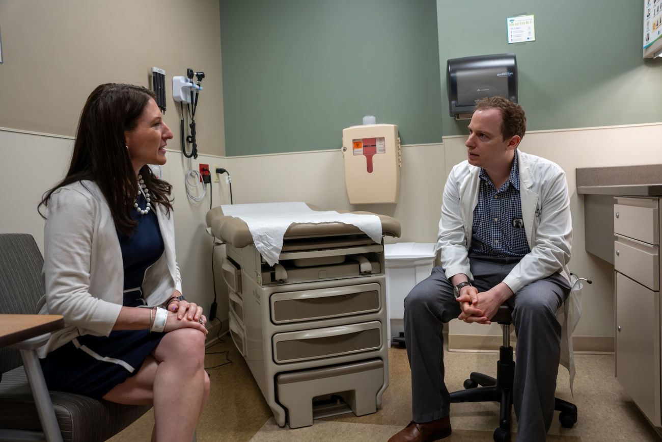 A doctor consults with a patient in an exam room