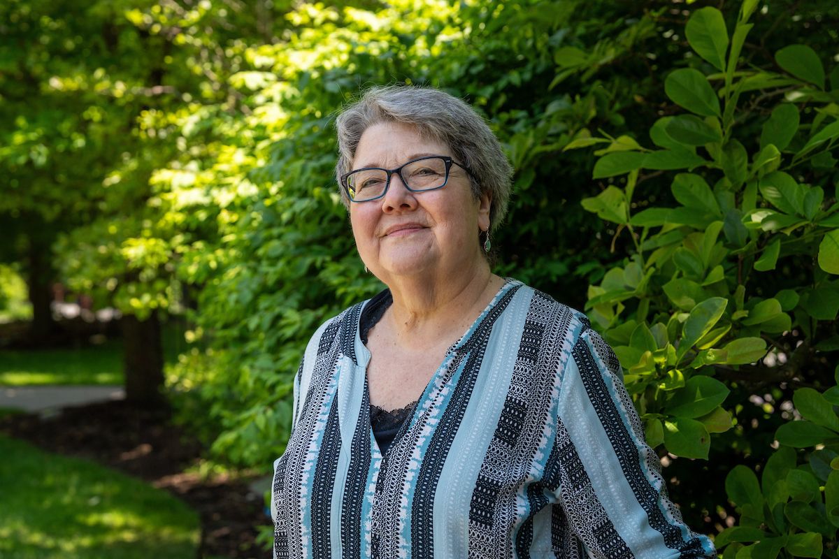 Patient Lynn Smith, treated for liver metastases with hepatic artery infusion, poses in Kaminski Park