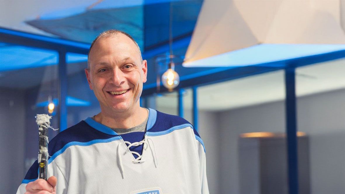 Peter Merlo poses with a hockey stick for the 11 Day Power Play