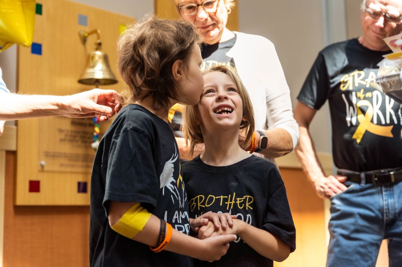 Pediatric patient Fiona and her brother in the lobby after ringing the Victory Bell