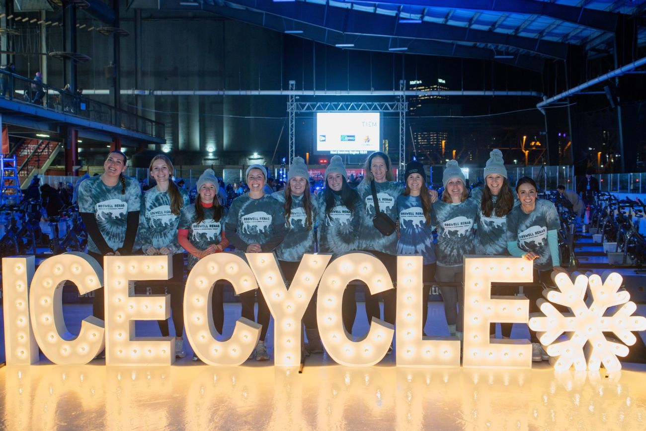 IceCycle team photo in front of light-up letters