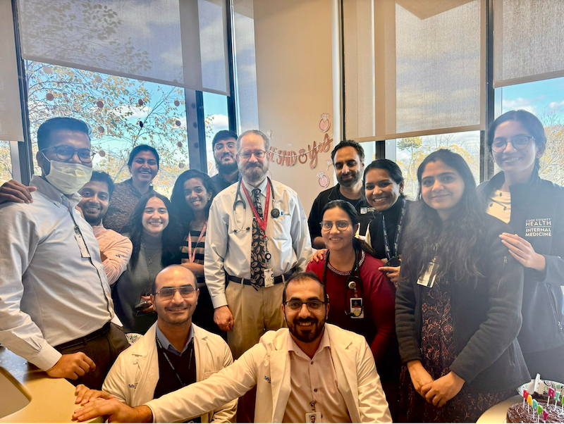 Dr. Ellis Levine stands with a group of hematology oncology fellows at a celebration