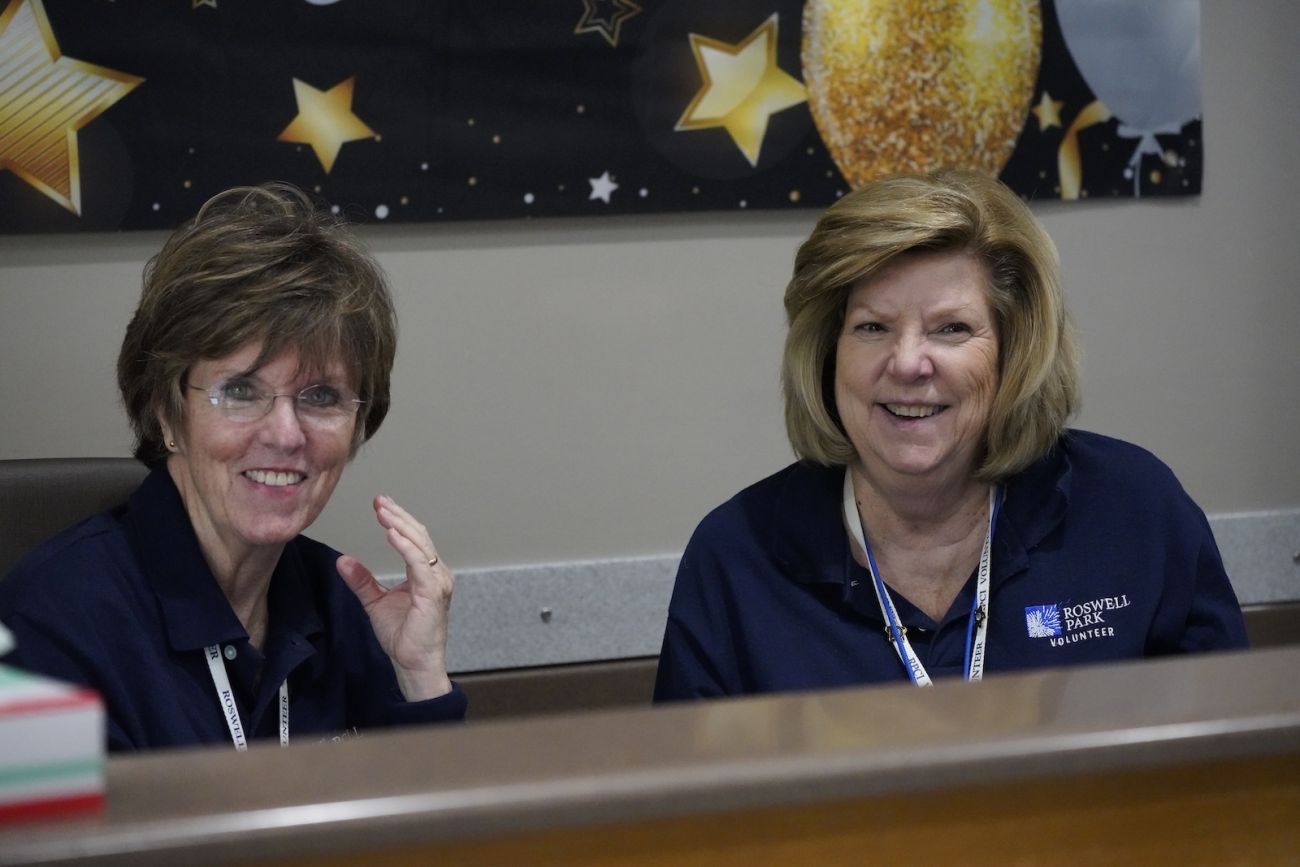 Two female volunteers sitting at a desk
