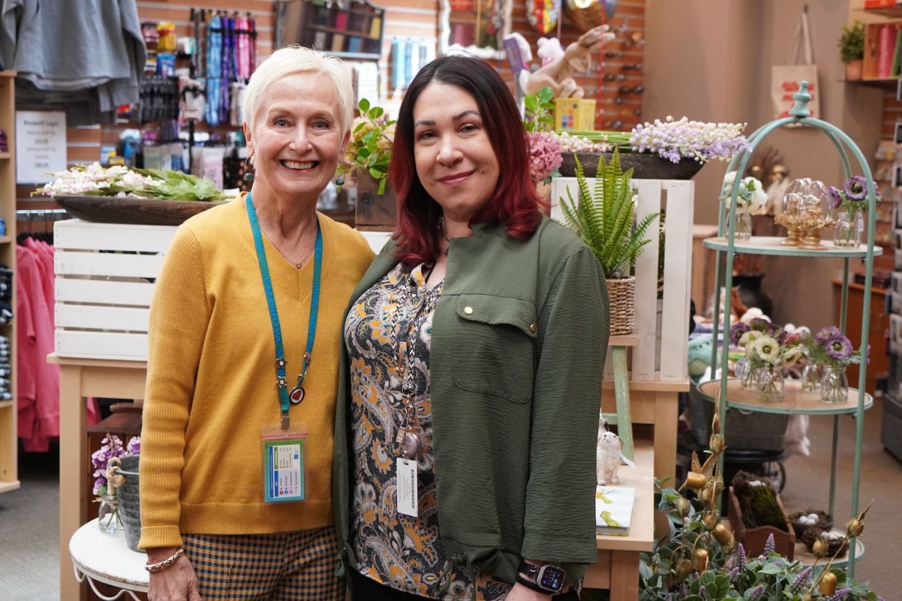 Two female gift shop volunteers in a hospital