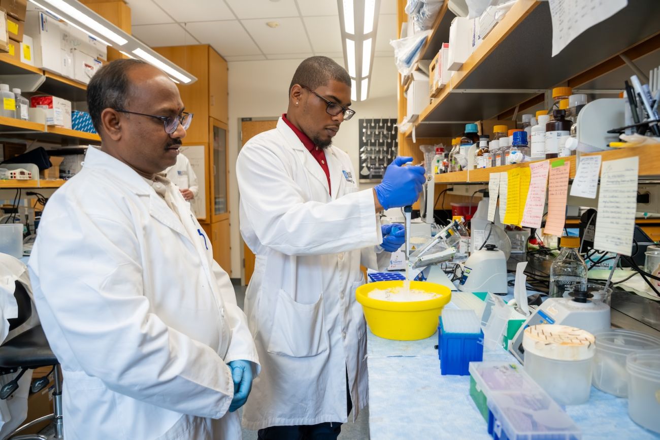 A college intern in the SURE-CAN Program works alongside a Roswell Park scientist 