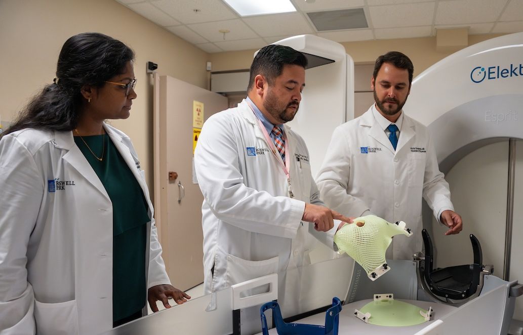 6 radiation oncologists, including residents and Dr. Simon Fung, smile and pose for a photo