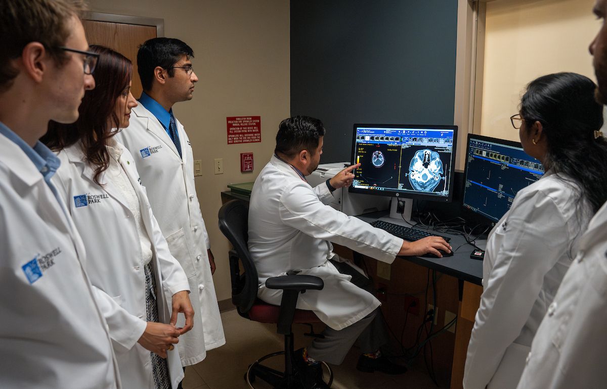 Dr. Fung Kee Fung reviews a scan with residents 