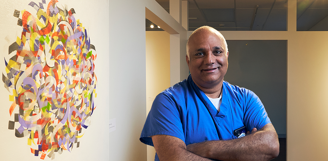 Dr. Khurshid Guru poses in the Art Heals gallery