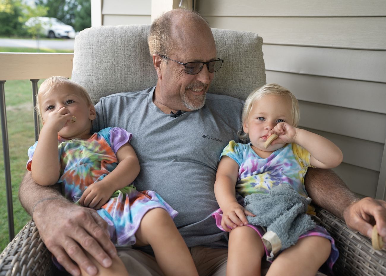Grandfather holds two grandaughters