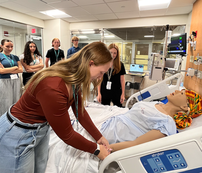 A student in the Buffalo Health Explorations program works on a test patient in the Nursing Center 