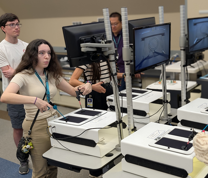 A student in the Buffalo Health Exploration program works on a robotic surgery simulation