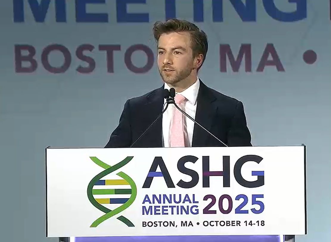 A scientist speaking behind a podium at a research conference