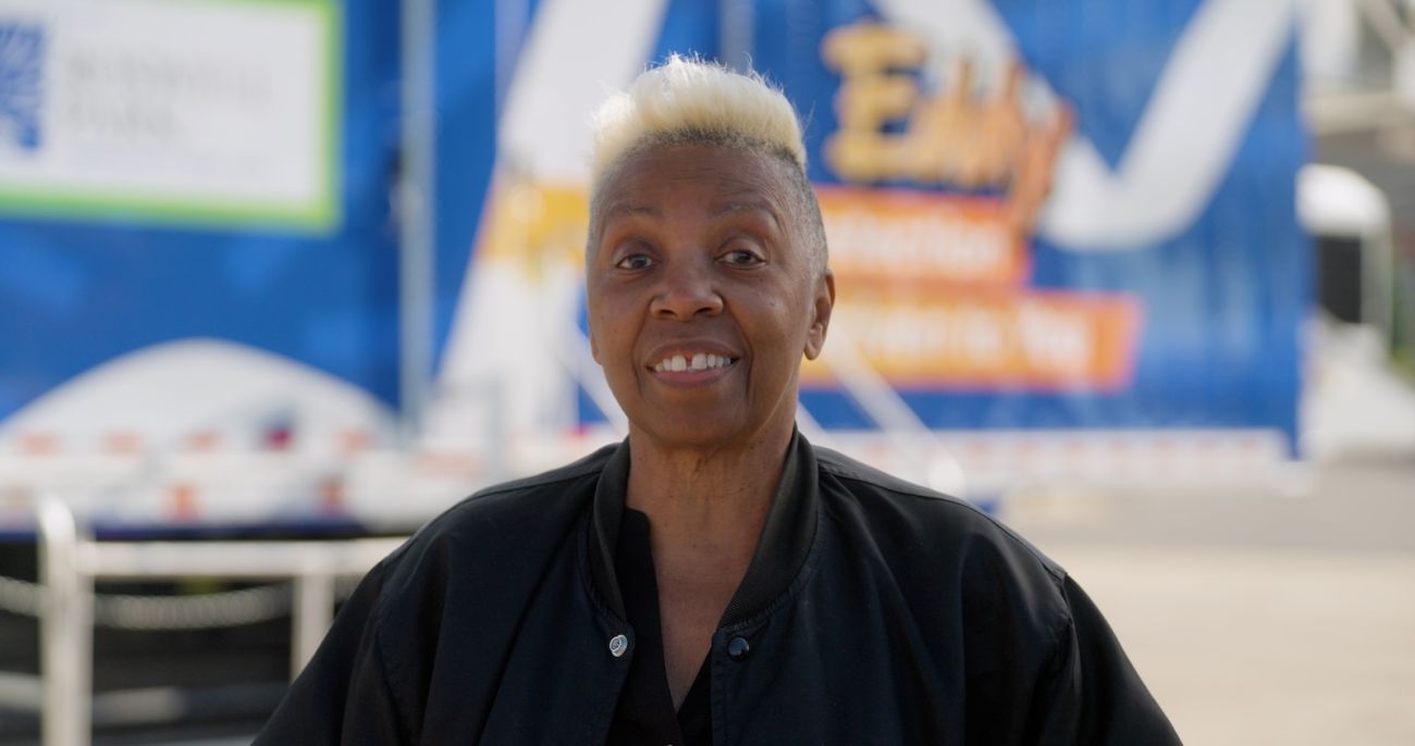 Barbara Glover stands in front of the mobile lung cancer screening unit Eddy.