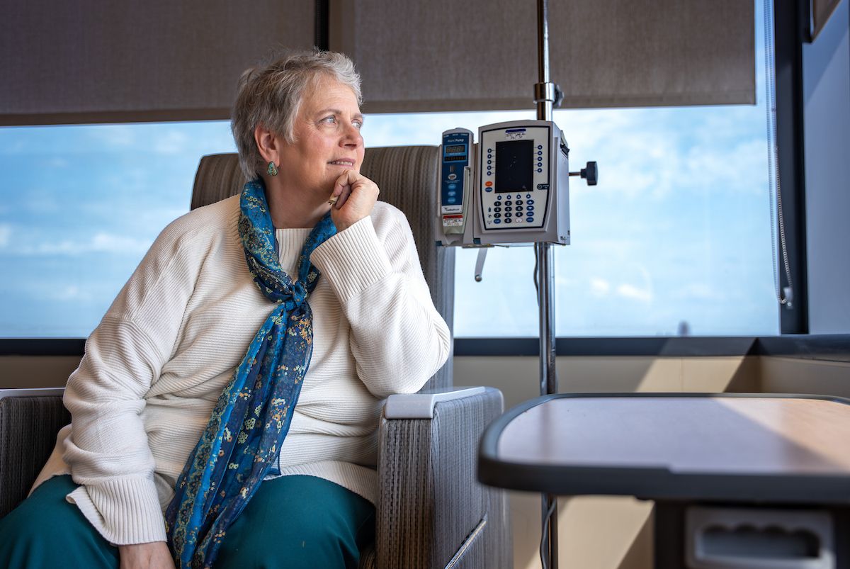 Roswell Park patient sits in hospital room looking out windown