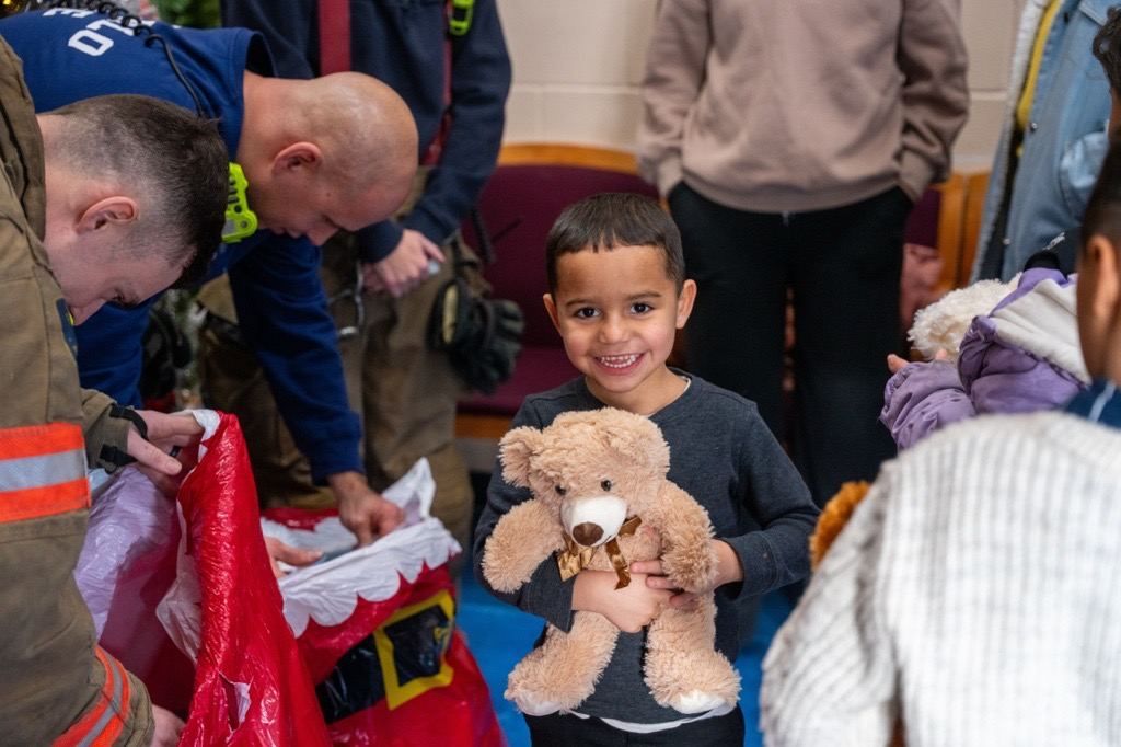 Child holds a teddy bear donated by Roswell Park employees.