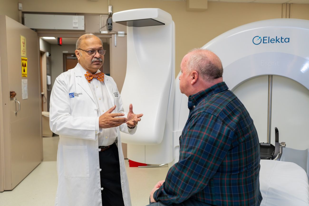 A doctor discusses a radiation procedure with a patient.