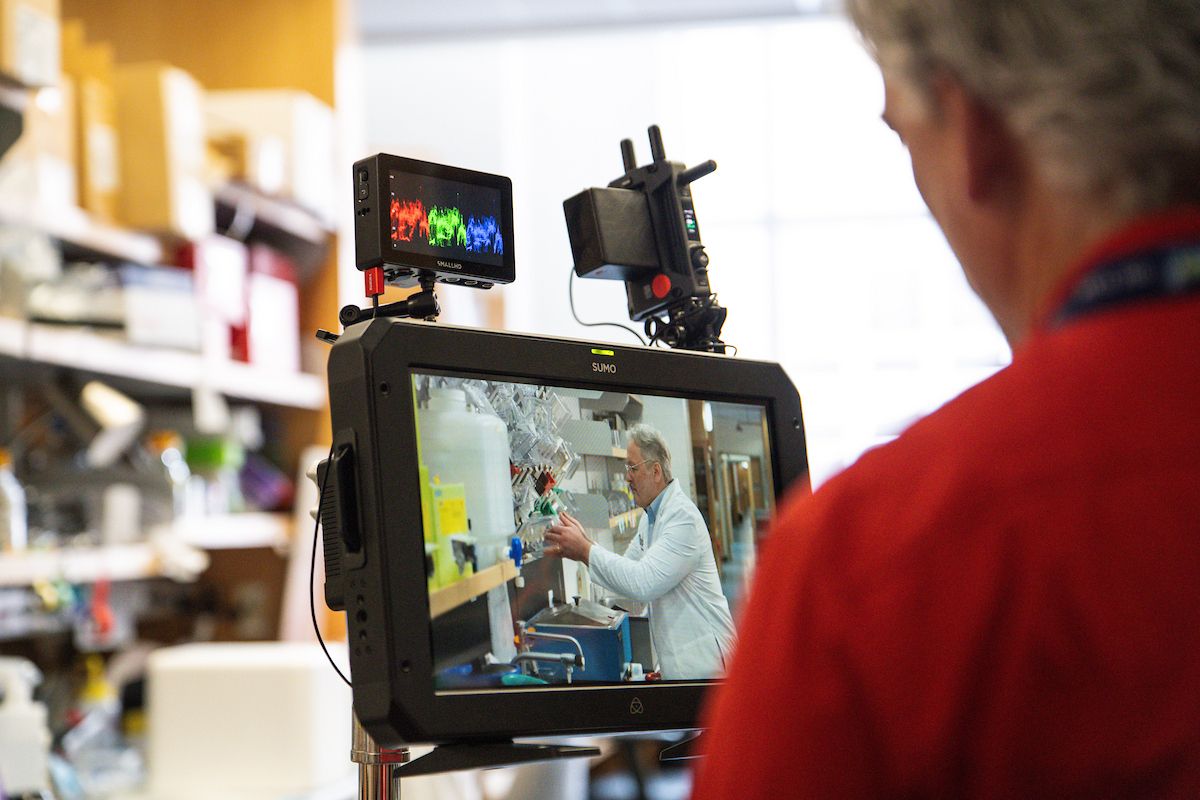 Man watches doctor being filmed as he does research