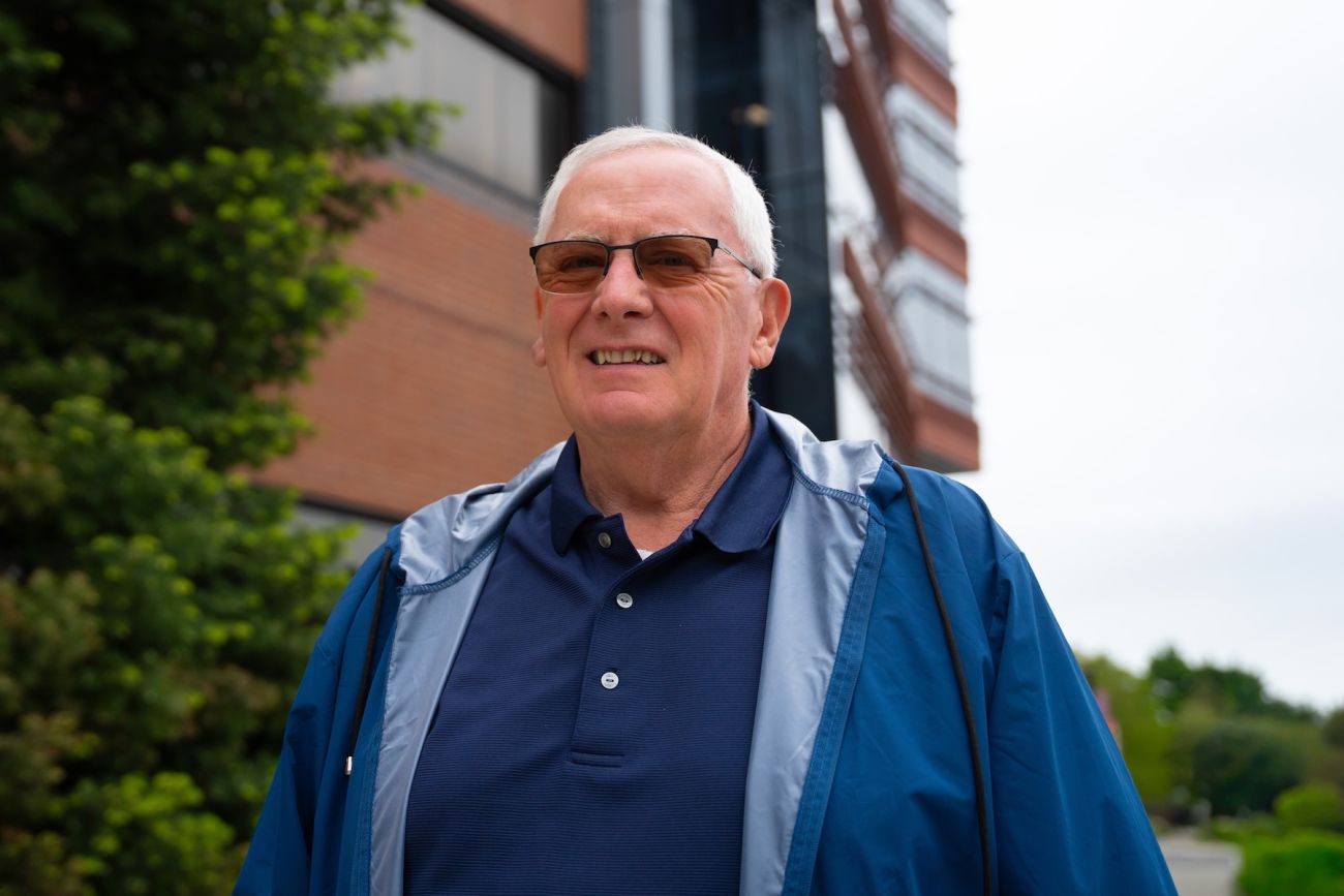A man stands outside in sunglasses