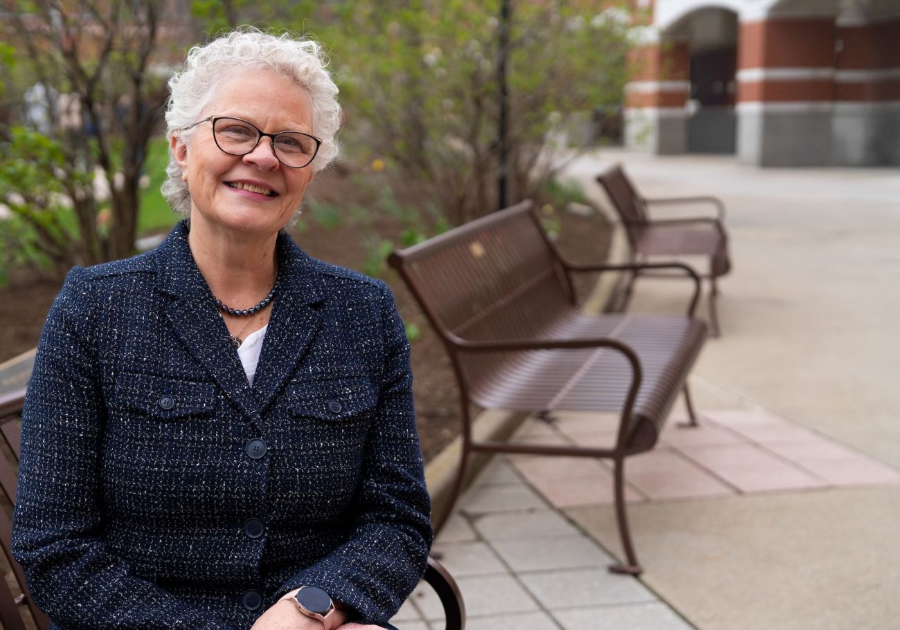A woman sits outdoor in a park
