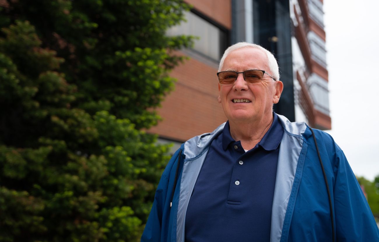 A man stands outside a hospital