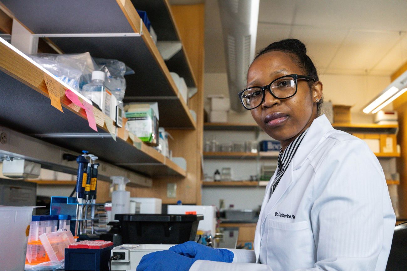 Dr. Catherine Rono works at a lab bench