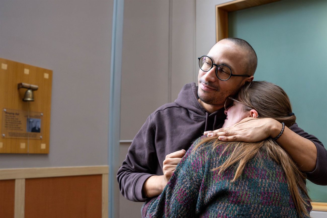 A patient holds a loved one close as the celebrate recovery in the lobby of Roswell Park