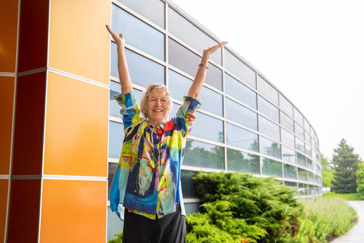 Photo of Barbara Widrig, liver cancer patient at Roswell Park, with her arms raised
