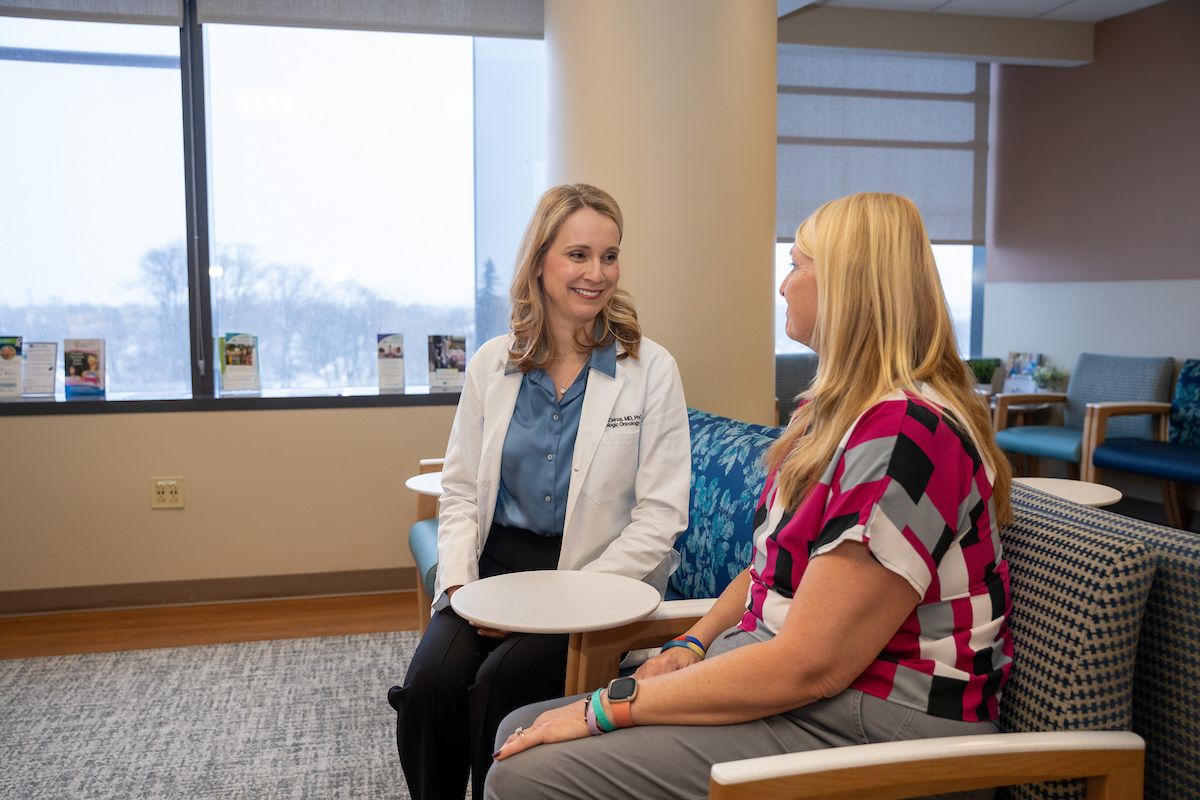Dr. Emese Zsiros sits with a patient in the lobby of the gynecology center 